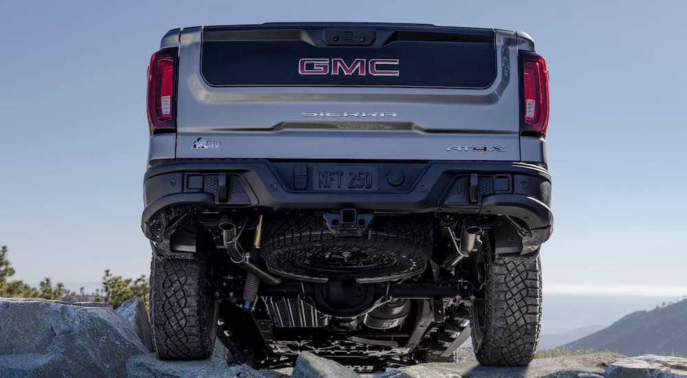 A grey 2025 GMC Sierra AT4x AEV Edition is shown from the rear at a low angle.