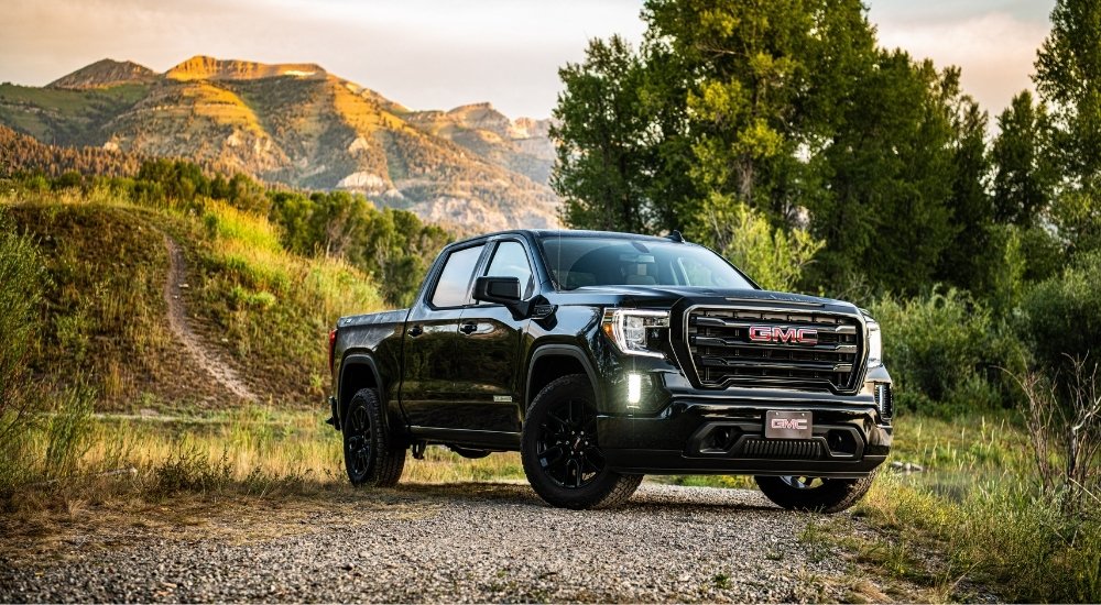 A black 2024 GMC Sierra 1500 Elevation parked off-road.