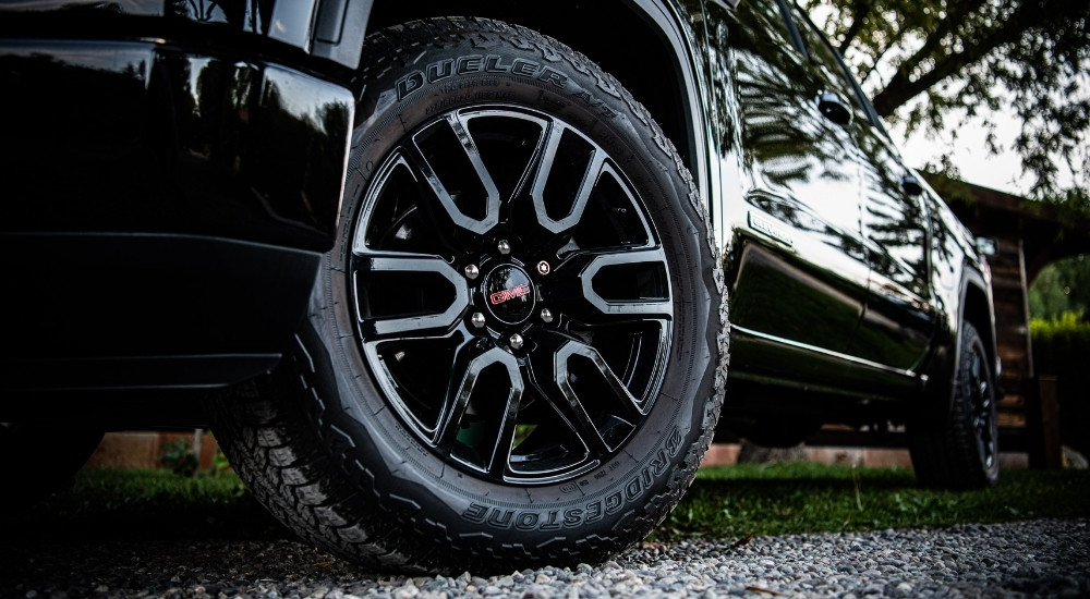 The wheel of a black 2025 GMC Sierra 1500.