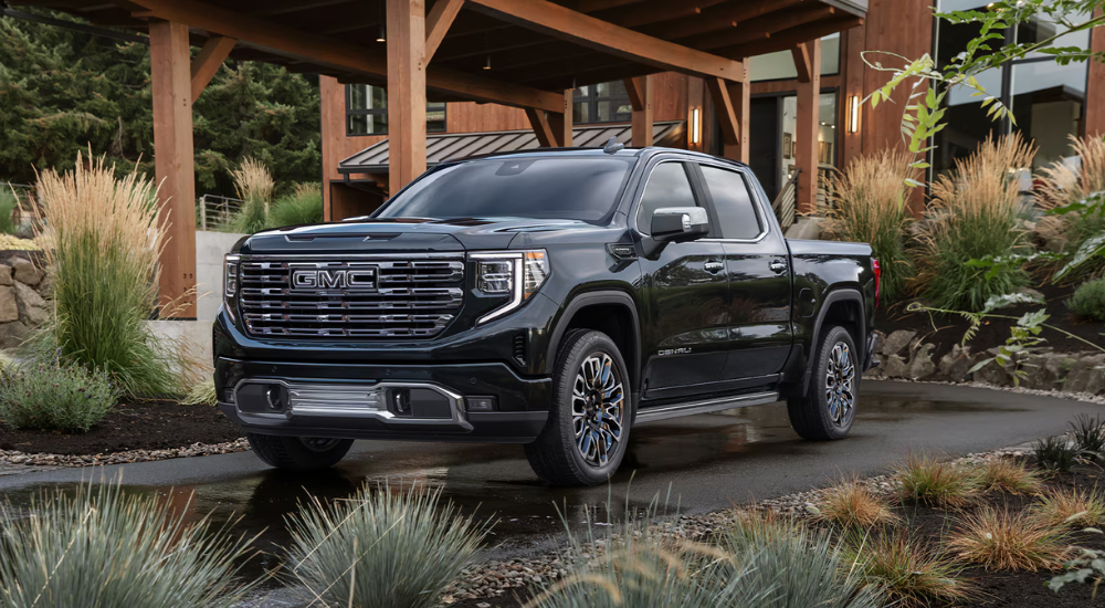 Black 2026 GMC Sierra 1500 parked in front of a house