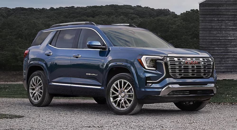 A blue 2026 GMC Terrain Denali parked offroad.