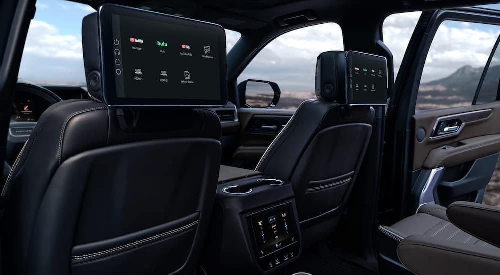 Rear black interior and dual infotainment screens in a 2026 GMC Yukon.
