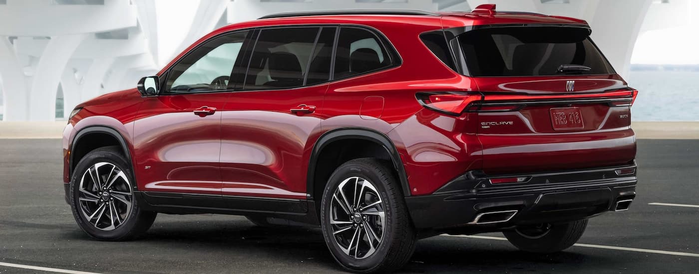 Rear of a red 2026 Buick Enclave parked on a driveway.