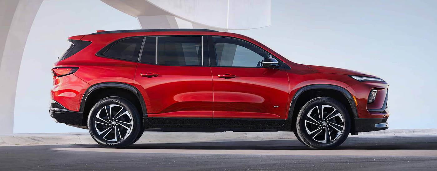 Side of a red 2027 Buick Enclave parked.