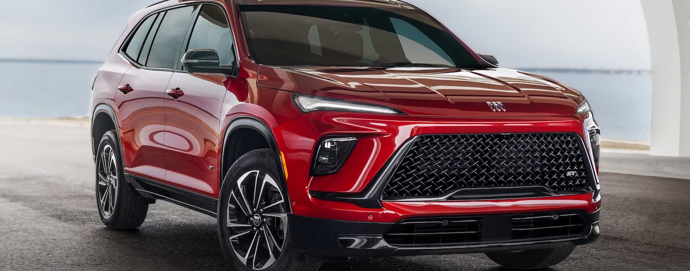A red 2025 Buick Enclave is parked on pavement.