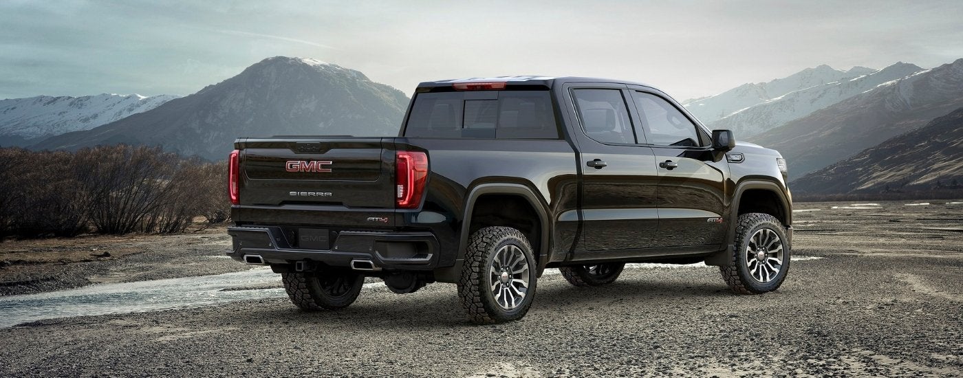 A black 2019 GMC Sierra 1500 AT4 is shown near mountains.