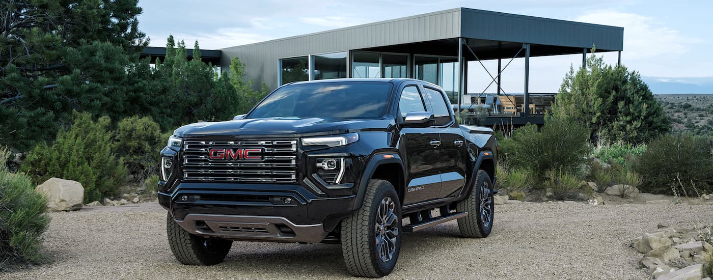 A black 2025 GMC Canyon Denali is shown from the front at an angle.
