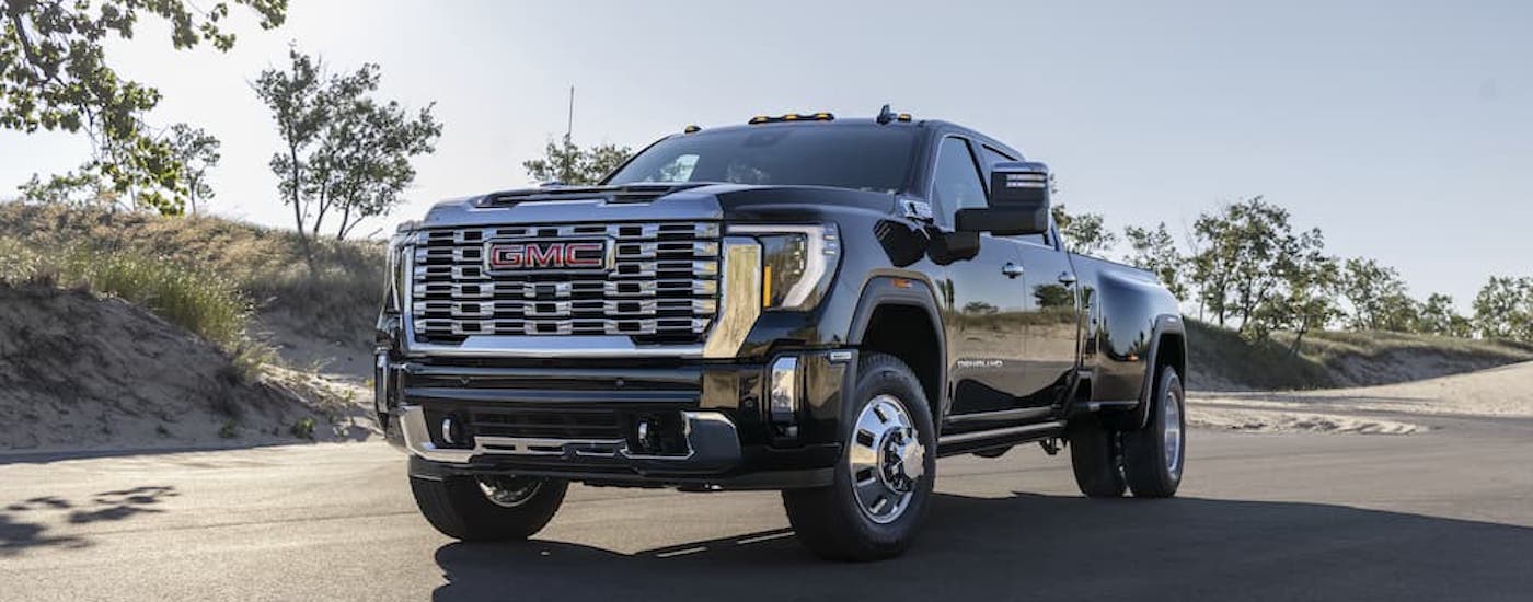A black 2025 GMC Sierra 3500 Denali is shown from the front at an angle after leaving a GMC dealer near Wayzata.