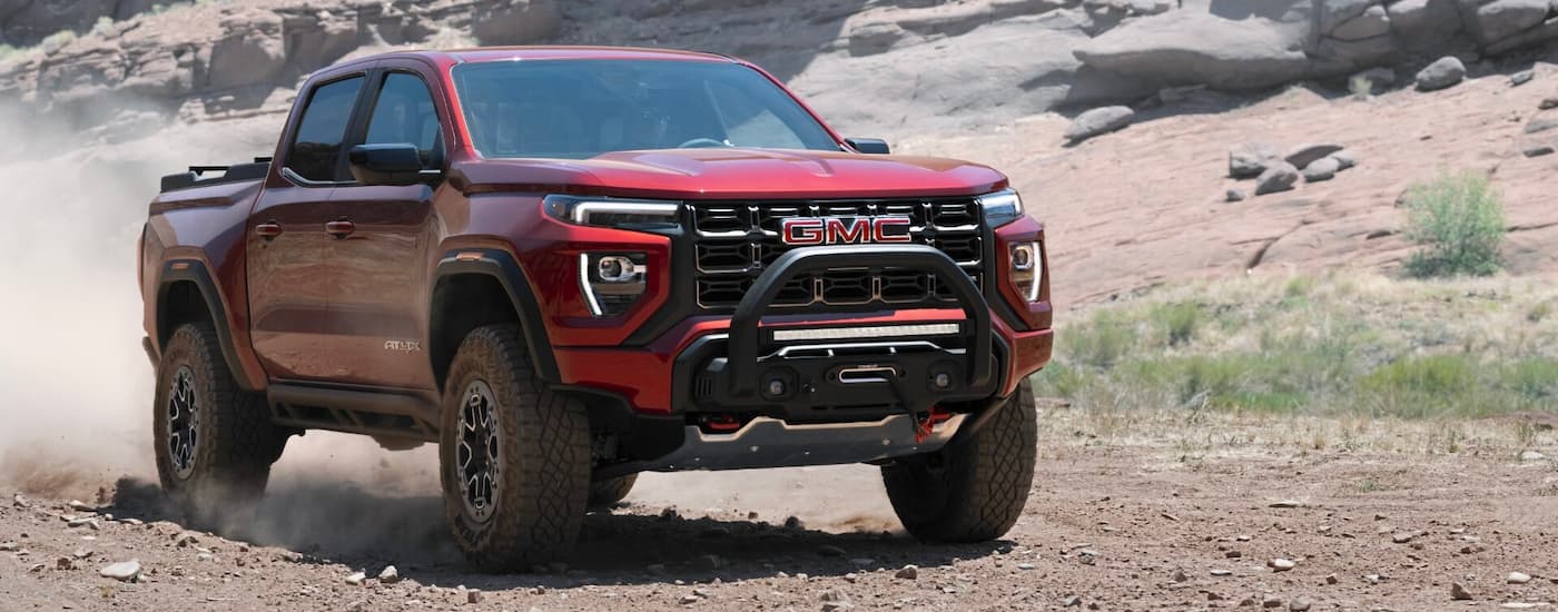 A red 2023 GMC Canyon AT4X parked off-road